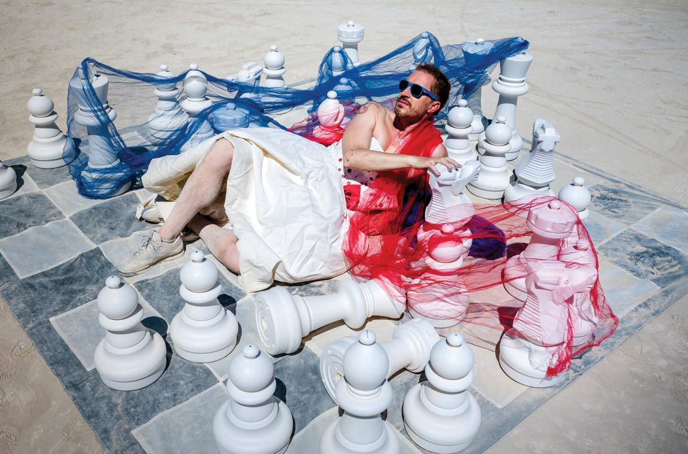 photo of Andrew Sean Greer lying on a giant chess board